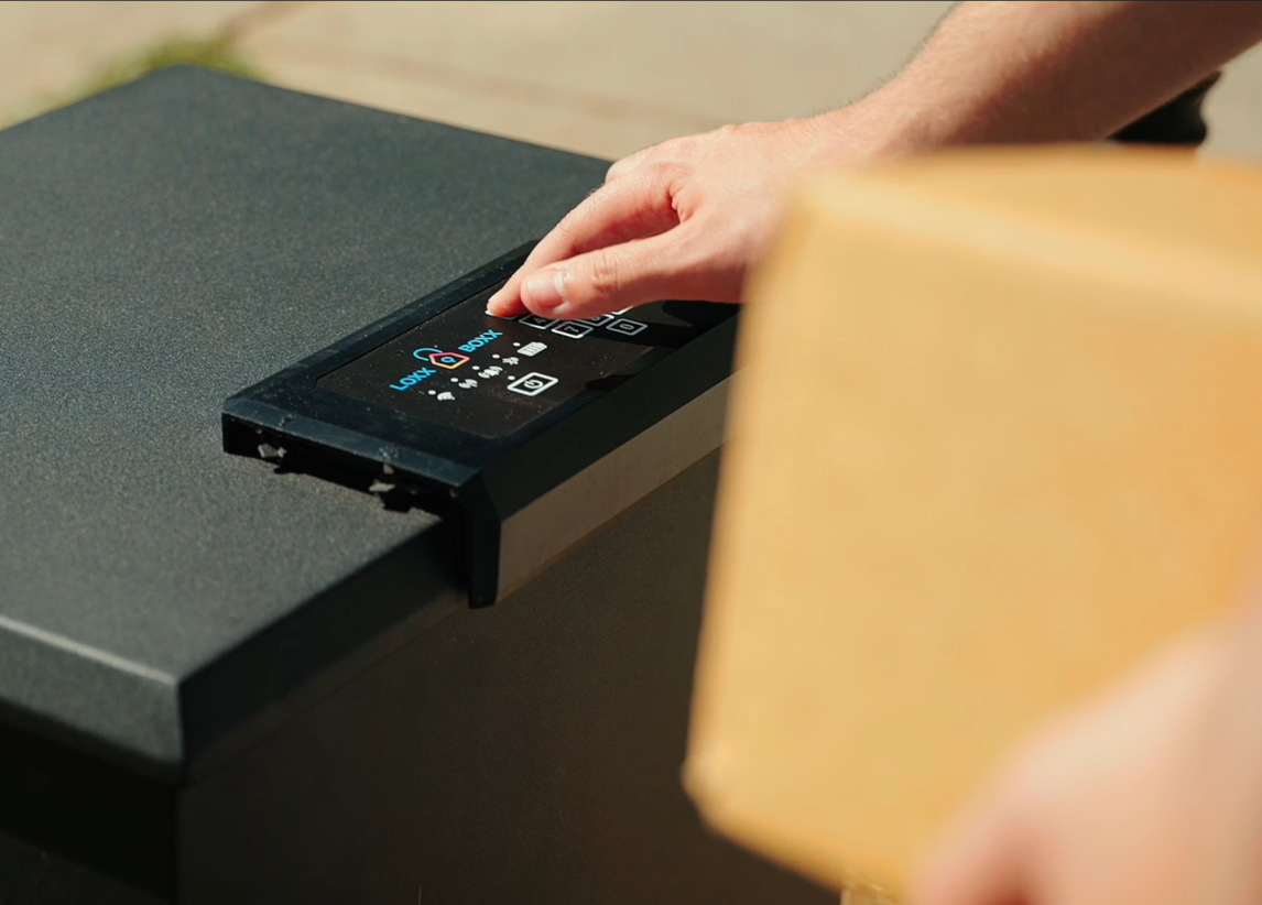 A secure Loxx Boxx on a porch with a delivered package inside, conveying safety and peace of mind.